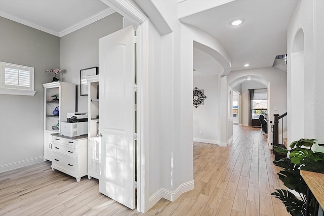 hall featuring light hardwood / wood-style flooring and ornamental molding