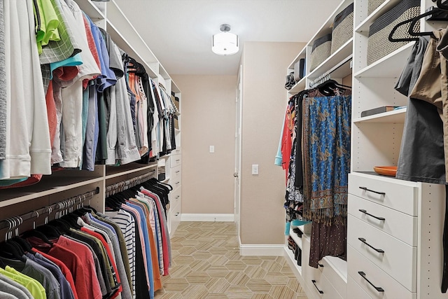 spacious closet with light parquet flooring