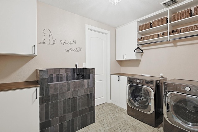 laundry room with cabinets and separate washer and dryer