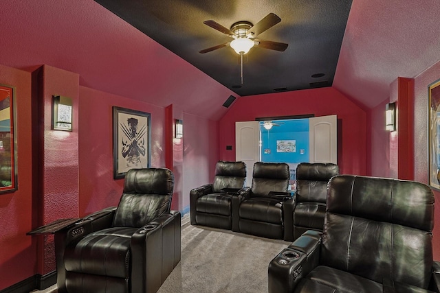 home theater room with a textured ceiling, light carpet, ceiling fan, and vaulted ceiling