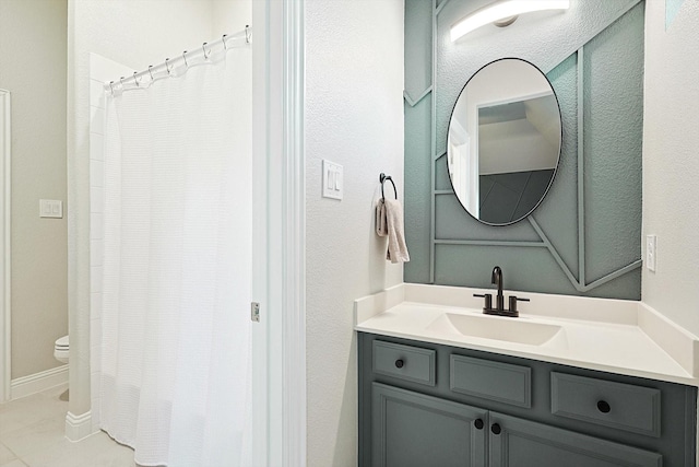 bathroom featuring tile patterned flooring, vanity, and toilet