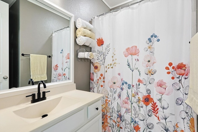 bathroom with vanity and ornamental molding