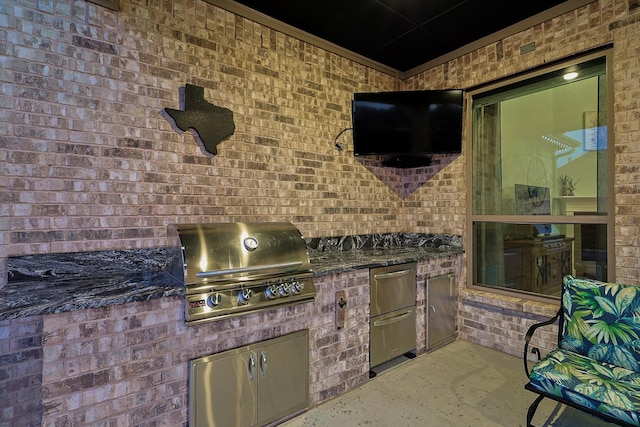 view of patio featuring an outdoor kitchen and a grill