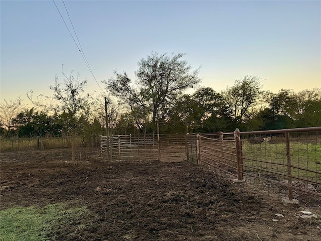 yard at dusk with a rural view