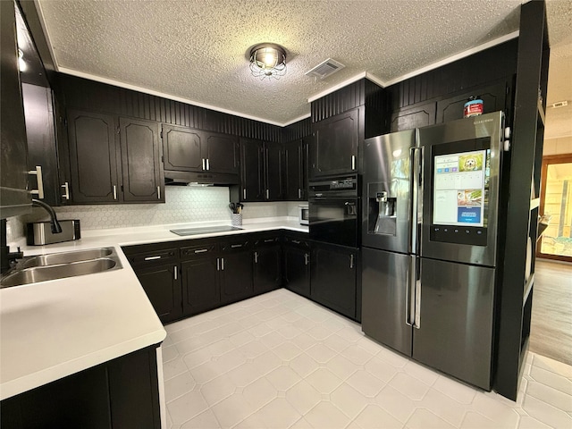 kitchen with backsplash, a textured ceiling, sink, black appliances, and light tile patterned floors