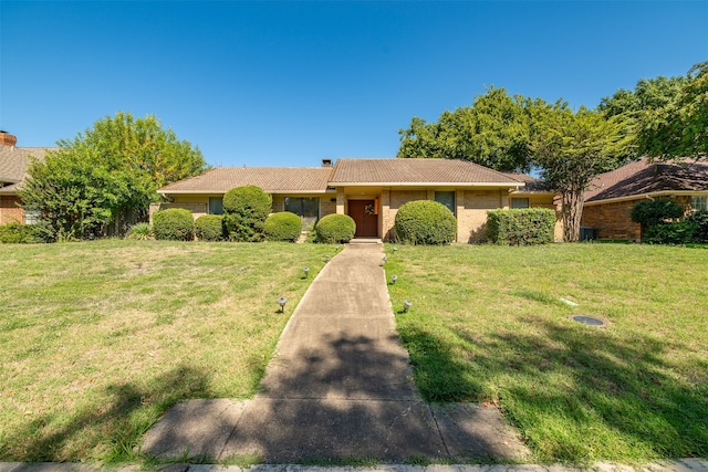 ranch-style home featuring a front yard