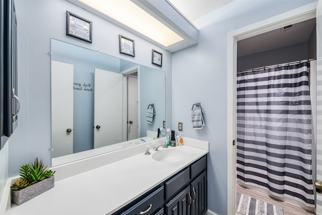 bathroom with vanity and hardwood / wood-style flooring