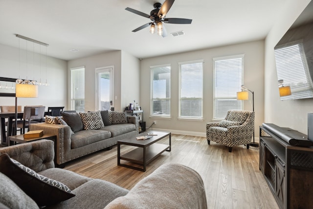 living room with ceiling fan and light wood-type flooring