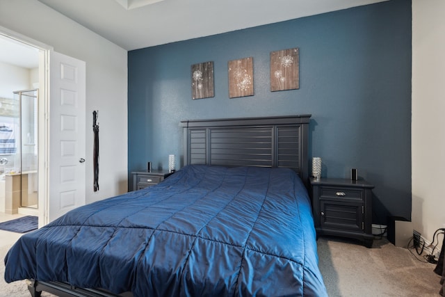 bedroom with carpet floors and connected bathroom