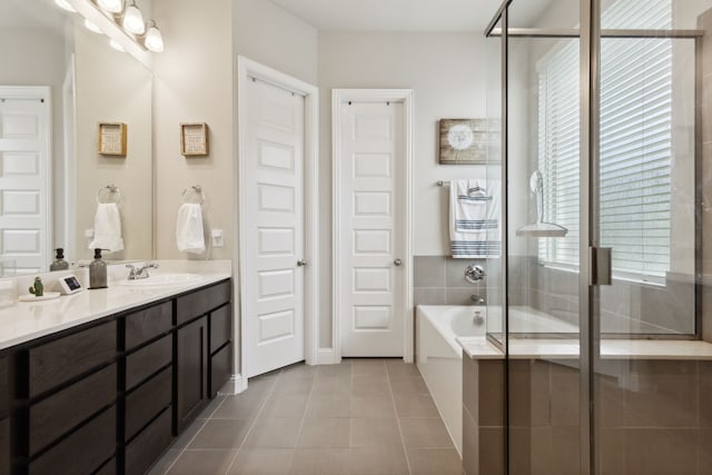 bathroom with independent shower and bath, vanity, and tile patterned floors