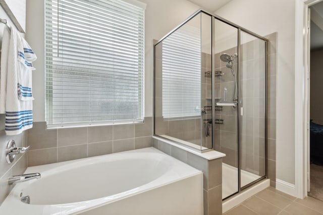 bathroom with tile patterned floors and independent shower and bath