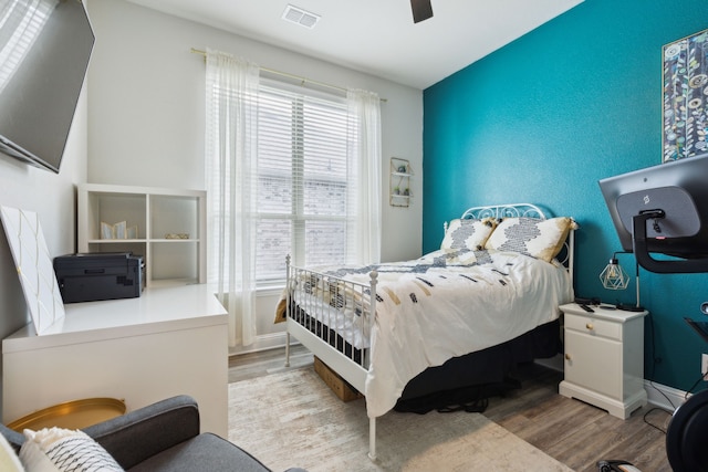 bedroom with light hardwood / wood-style flooring and ceiling fan