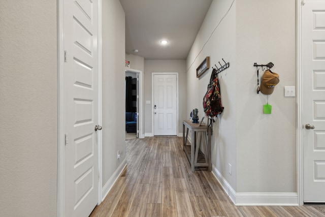 corridor with hardwood / wood-style floors