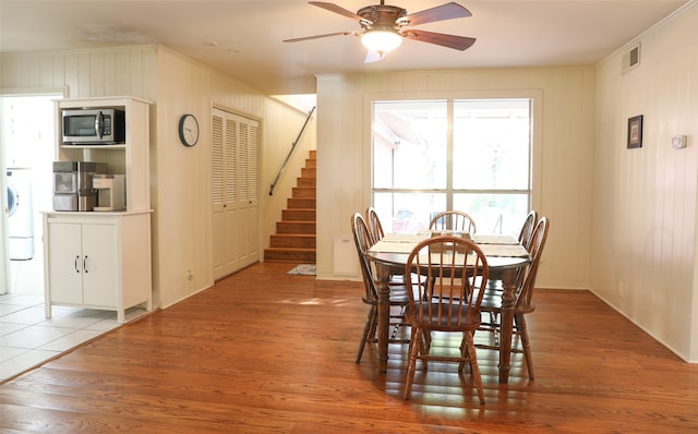 dining area with ornamental molding, hardwood / wood-style flooring, ceiling fan, and washer / dryer