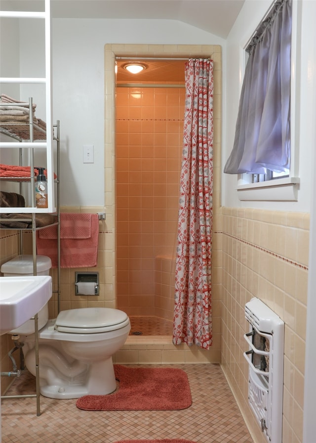 bathroom featuring tile walls, toilet, a shower with shower curtain, and tile patterned floors