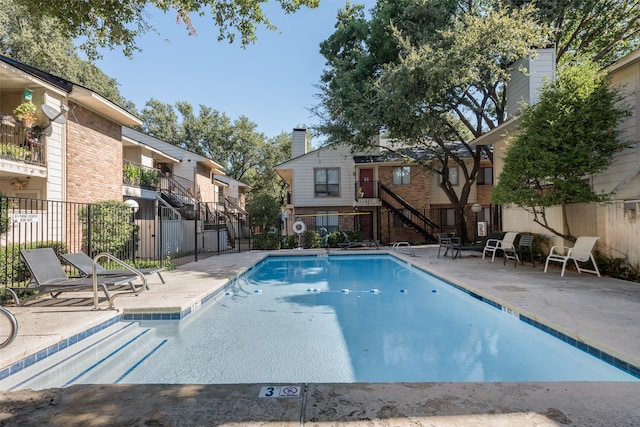 view of swimming pool with a patio