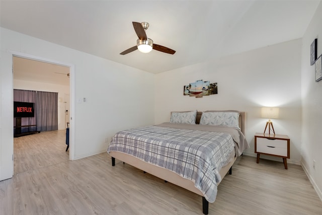 bedroom with light hardwood / wood-style flooring and ceiling fan