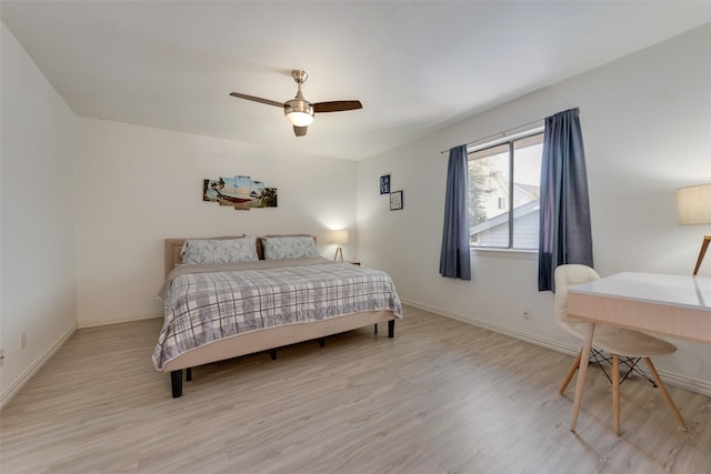 bedroom with light hardwood / wood-style floors and ceiling fan