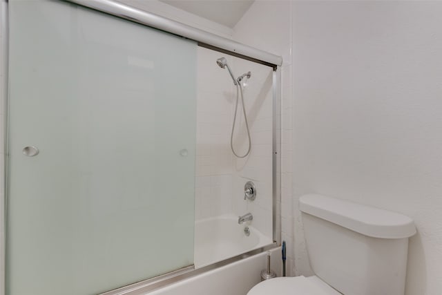 bathroom featuring shower / bath combination with glass door and toilet