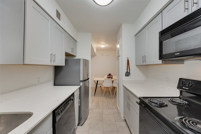 kitchen with white cabinets, black appliances, and light stone counters