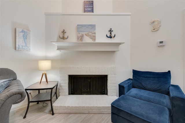 living room with a fireplace and hardwood / wood-style flooring