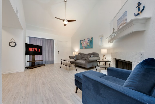 living room with high vaulted ceiling, ceiling fan, and light wood-type flooring