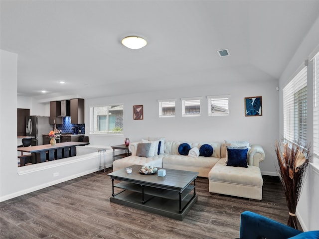 living room featuring lofted ceiling and dark hardwood / wood-style floors