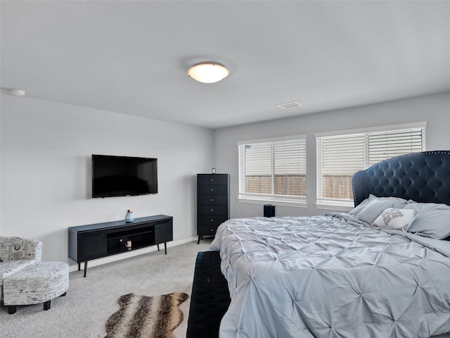 bedroom featuring light colored carpet