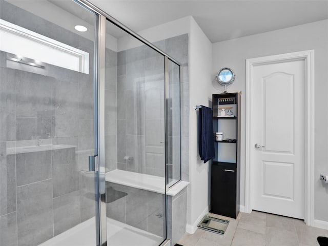 bathroom with tile patterned flooring and a shower with shower door