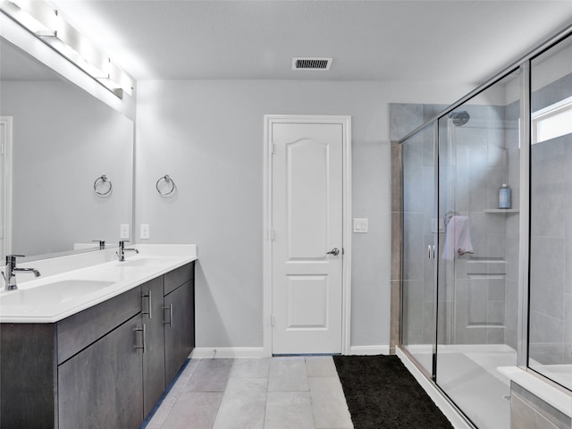 bathroom with vanity, walk in shower, and tile patterned floors