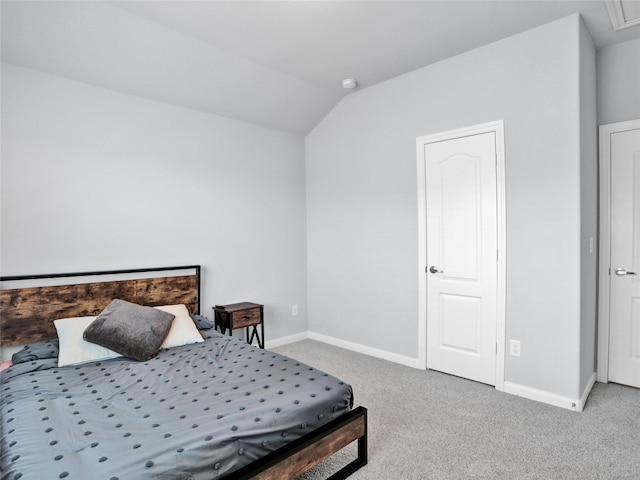 bedroom with lofted ceiling and carpet floors