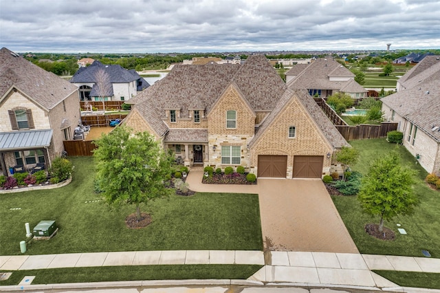 view of front of house with a garage and a front lawn