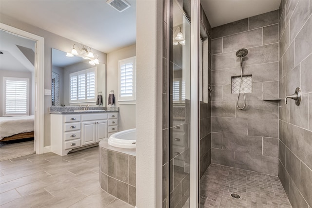 bathroom with vanity and independent shower and bath