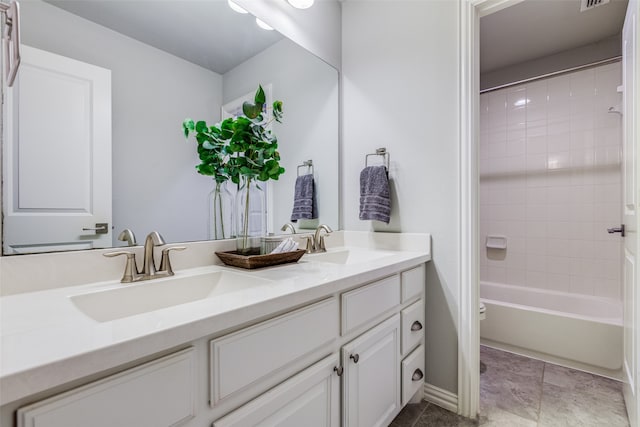 bathroom with vanity and tiled shower / bath combo