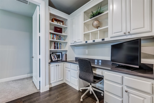 office area featuring dark hardwood / wood-style flooring and built in desk