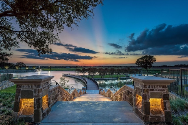 pool at dusk with a water view