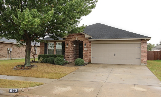 ranch-style home with a garage and a front lawn