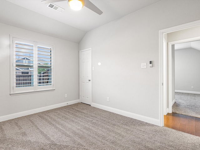 unfurnished room featuring lofted ceiling, wood-type flooring, and ceiling fan