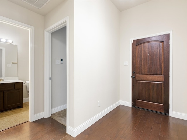 entrance foyer featuring dark hardwood / wood-style flooring and sink