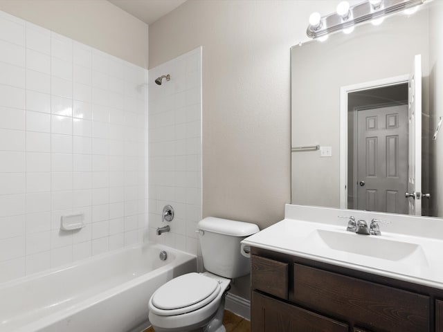 full bathroom with tiled shower / bath, toilet, and vanity