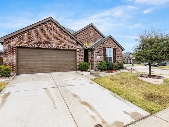 view of front of property featuring a garage and a front lawn