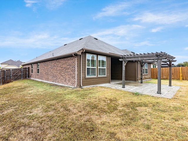 back of property featuring a yard, a patio, and a pergola