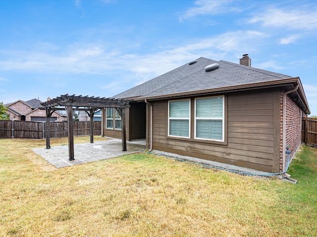 back of property featuring a yard, a pergola, and a patio area