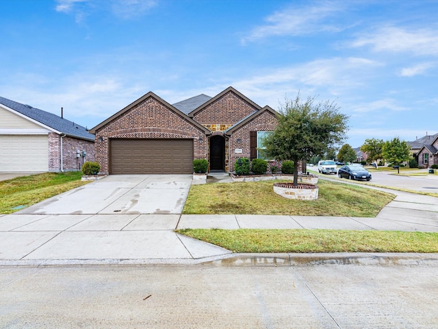 1200 Roadrunner Dr, Little Elm, TX 75068 - view of front of property featuring brick siding, an attached garage, a front lawn, and concrete driveway