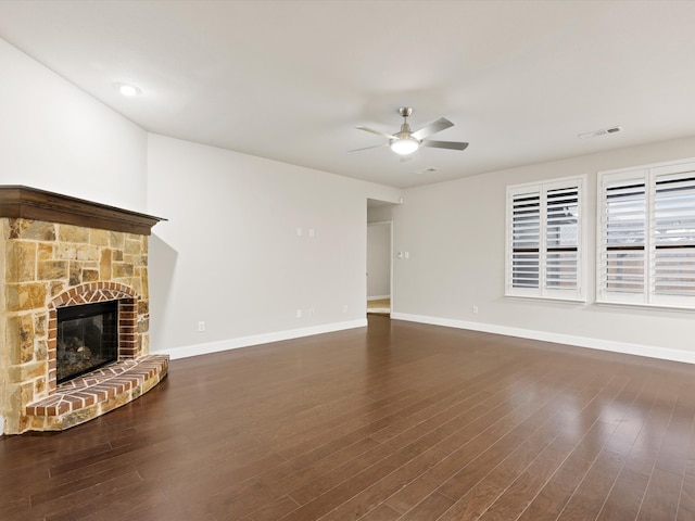 unfurnished living room with ceiling fan, dark hardwood / wood-style floors, and a fireplace