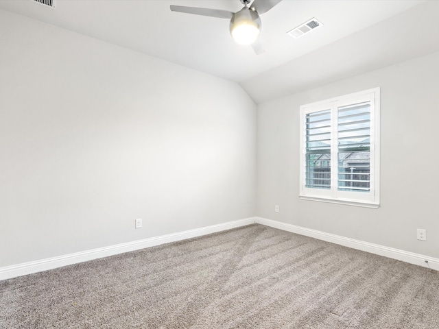 empty room with lofted ceiling, carpet, and ceiling fan