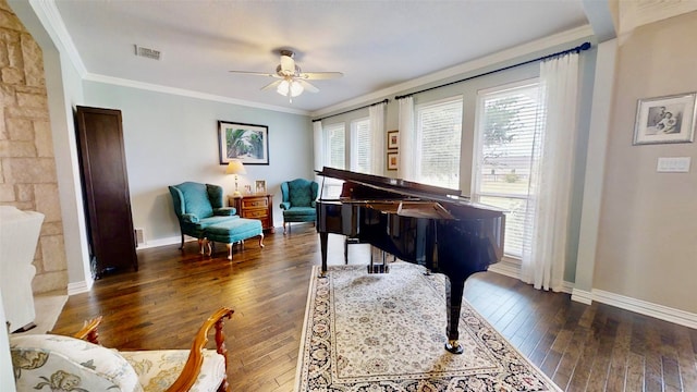 living area featuring ornamental molding, dark wood finished floors, visible vents, and baseboards