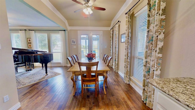 dining room with dark wood finished floors, baseboards, and ceiling fan