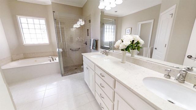 bathroom featuring a bath, a shower stall, ornamental molding, and a sink