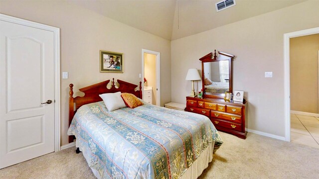 bedroom featuring light carpet, ensuite bath, visible vents, and baseboards